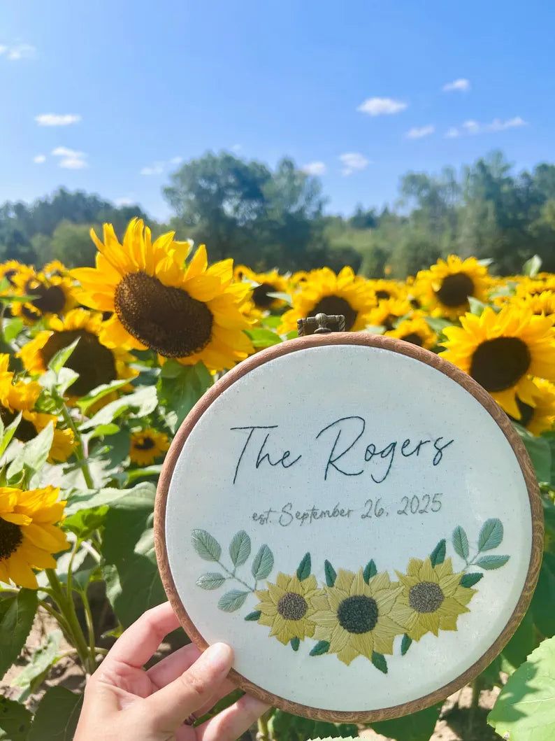 commemorative wedding embroidery hoop in front of sunflower field