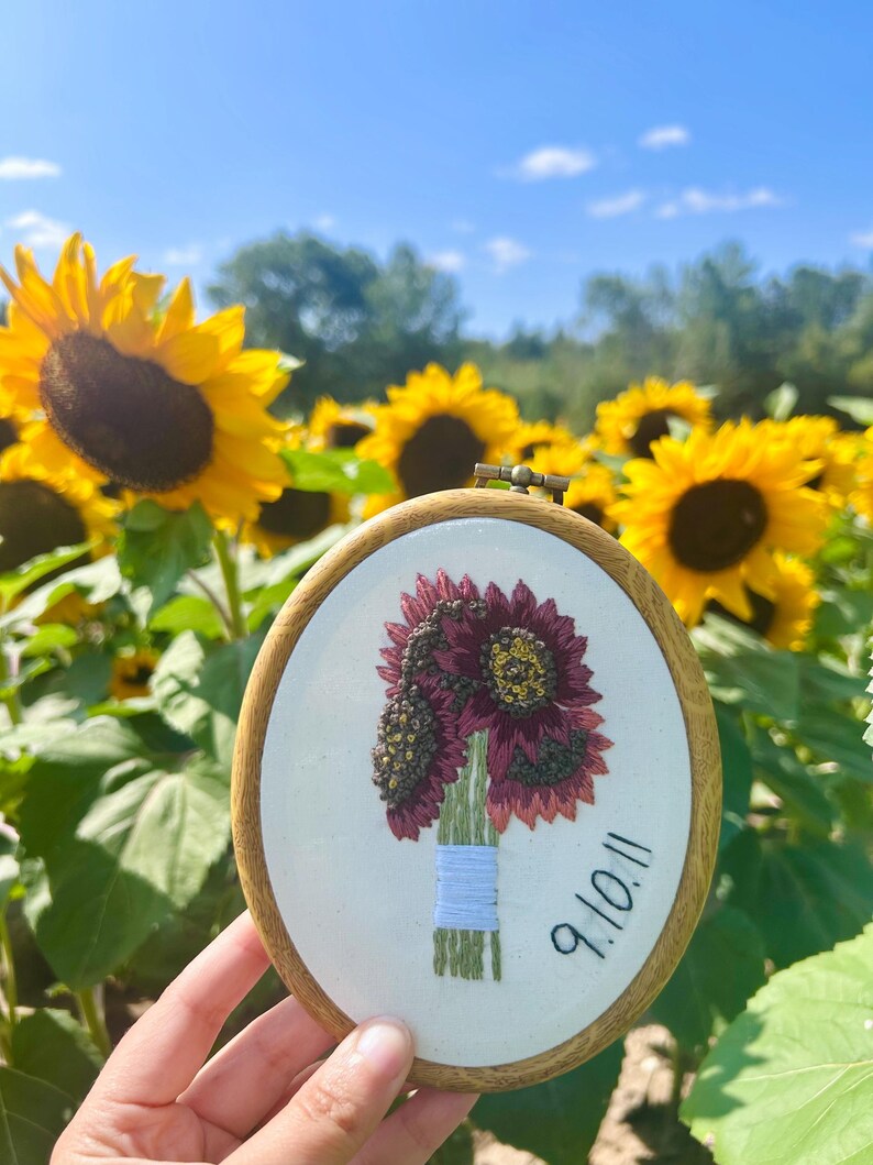 commemorative wedding red sunflower bouquet embroidery hoop with sunflowers behind in background