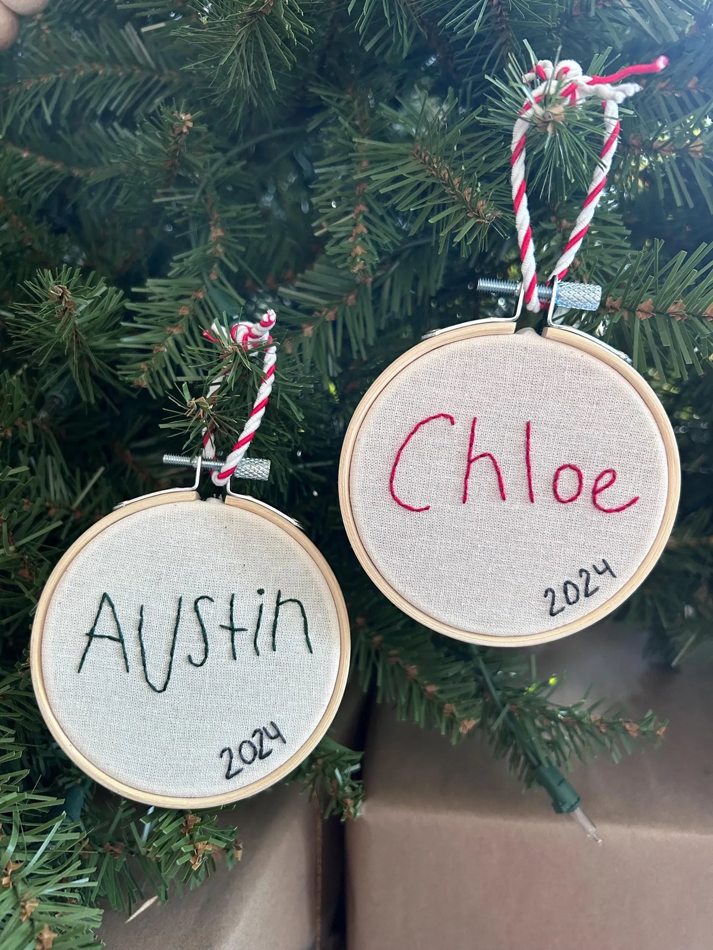 two children’s handwritten name custom embroidery ornament on Christmas Tree