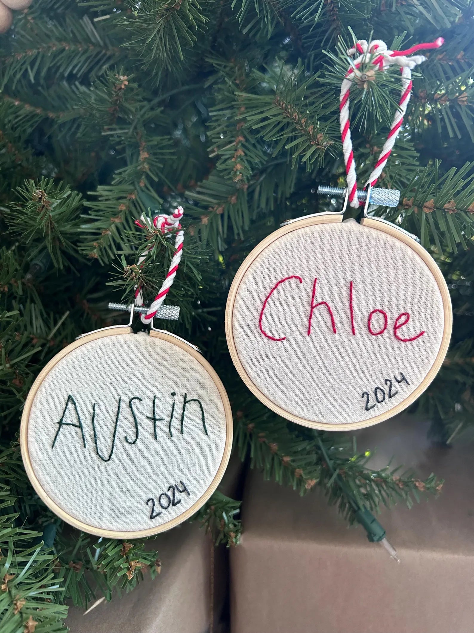 two children’s handwritten name custom embroidery ornament on Christmas Tree
